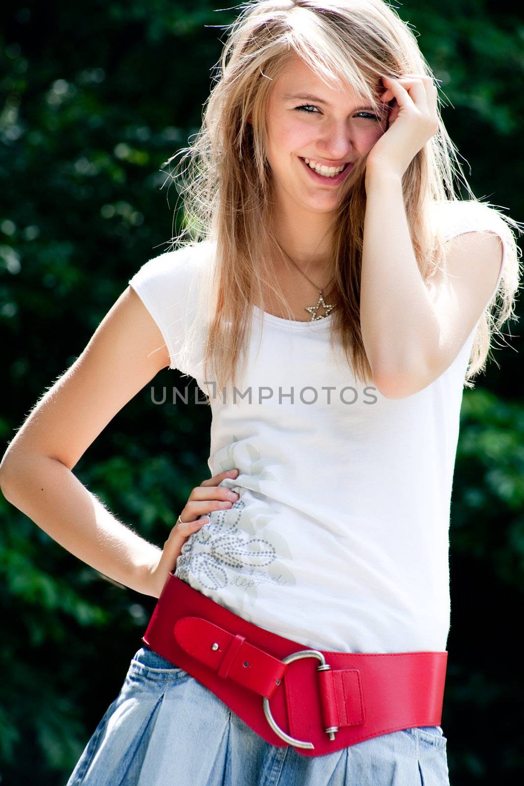 Teenage girl in fresh and happy mood outside in the park