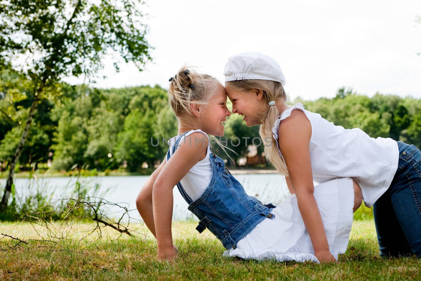 Two little girls in fresh colors in the park