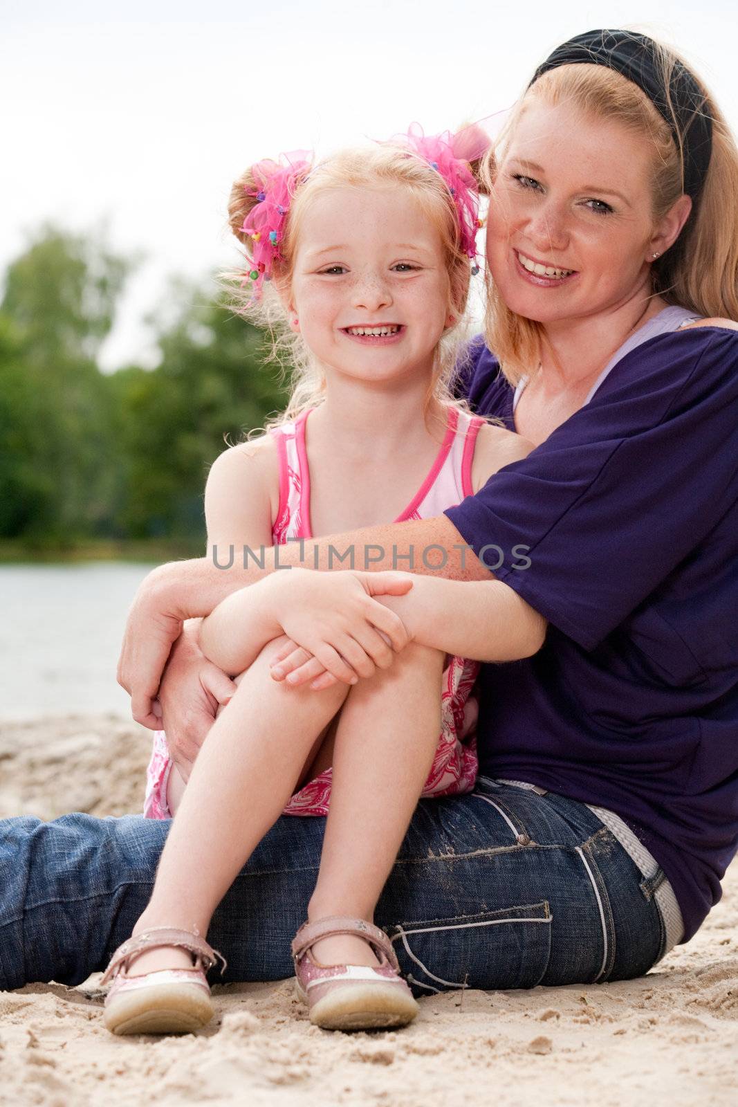 Mother and her little girl on the beach by DNFStyle
