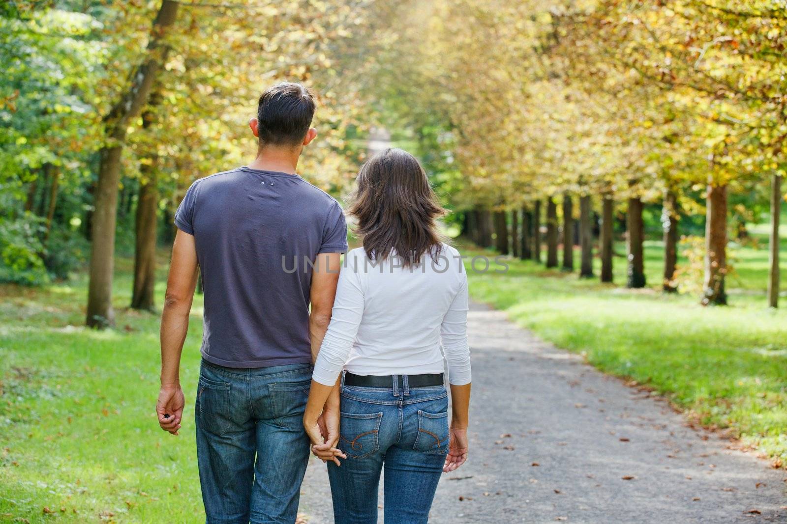 Young Couple Walking in autumn park by maxoliki