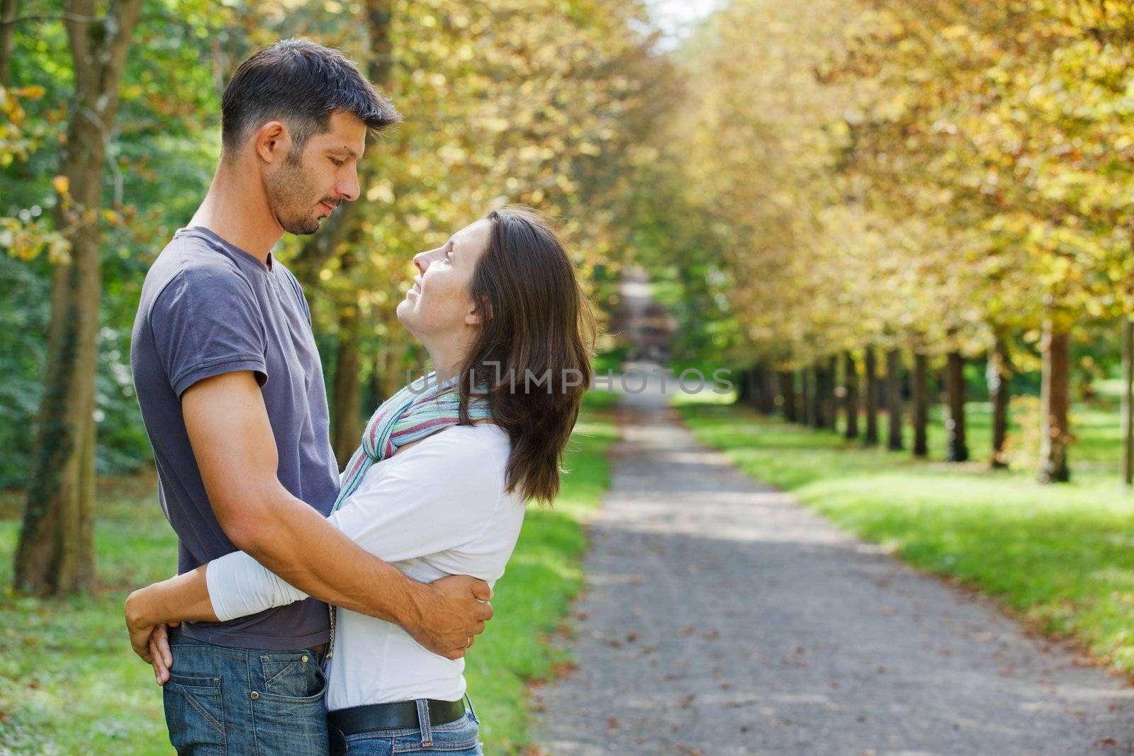 Romantic  Beautiful young couple walking in autumn park
