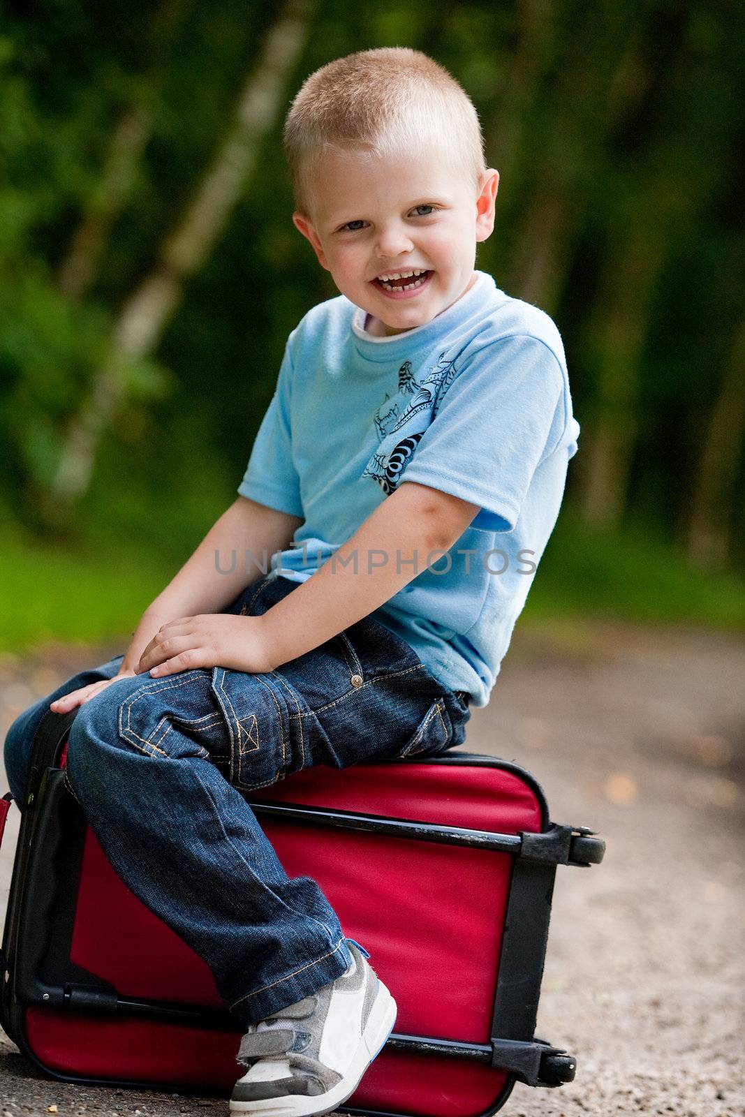Little boy sitting on his suitcase by DNFStyle