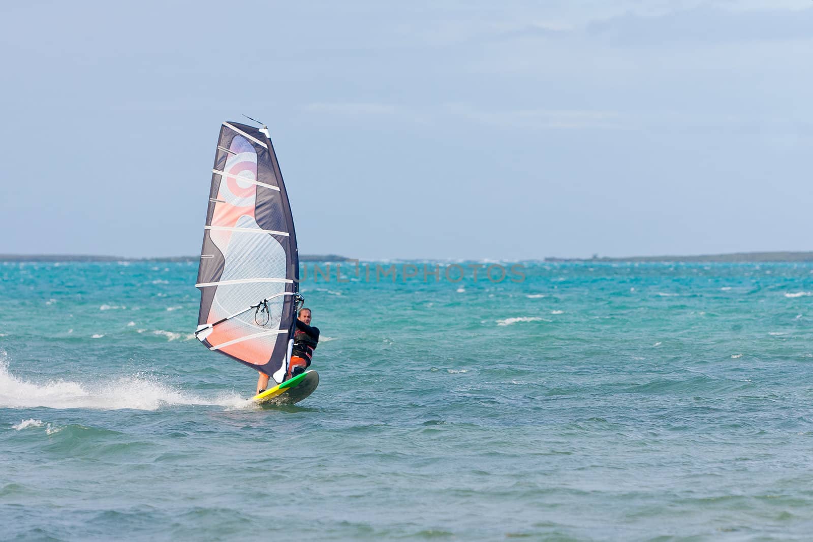Windsurfer enjoying his sport in the lagoon, Babaomby, Madagascar