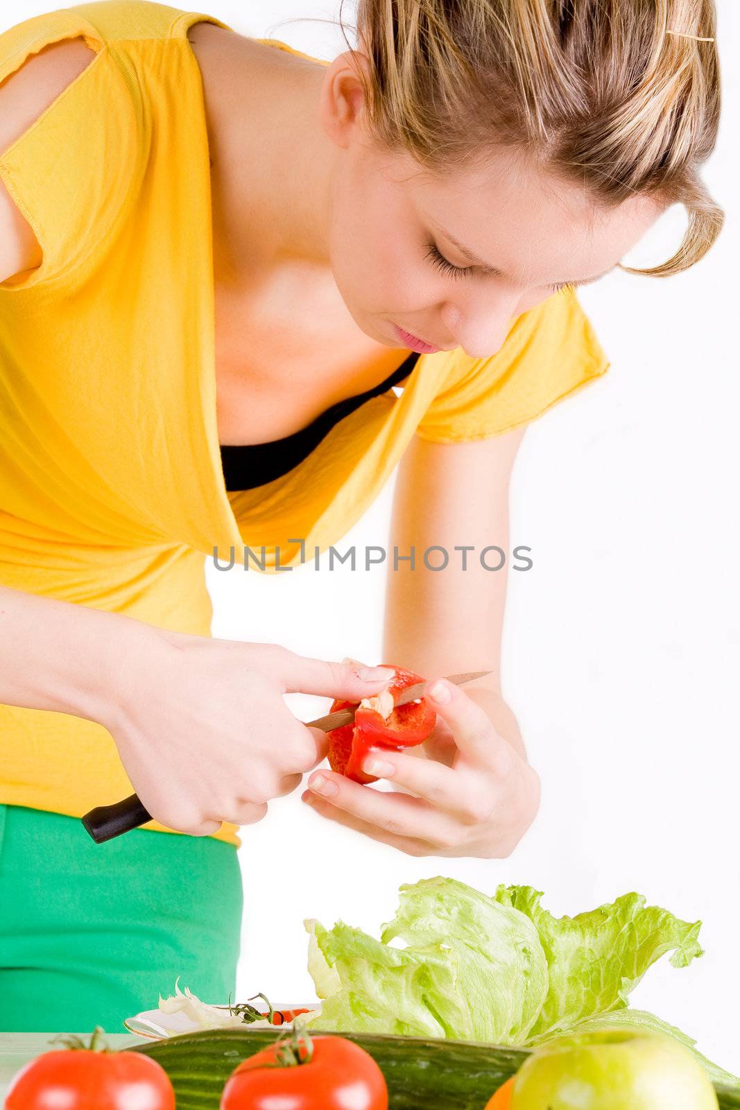 Young girl is making a delicious salad