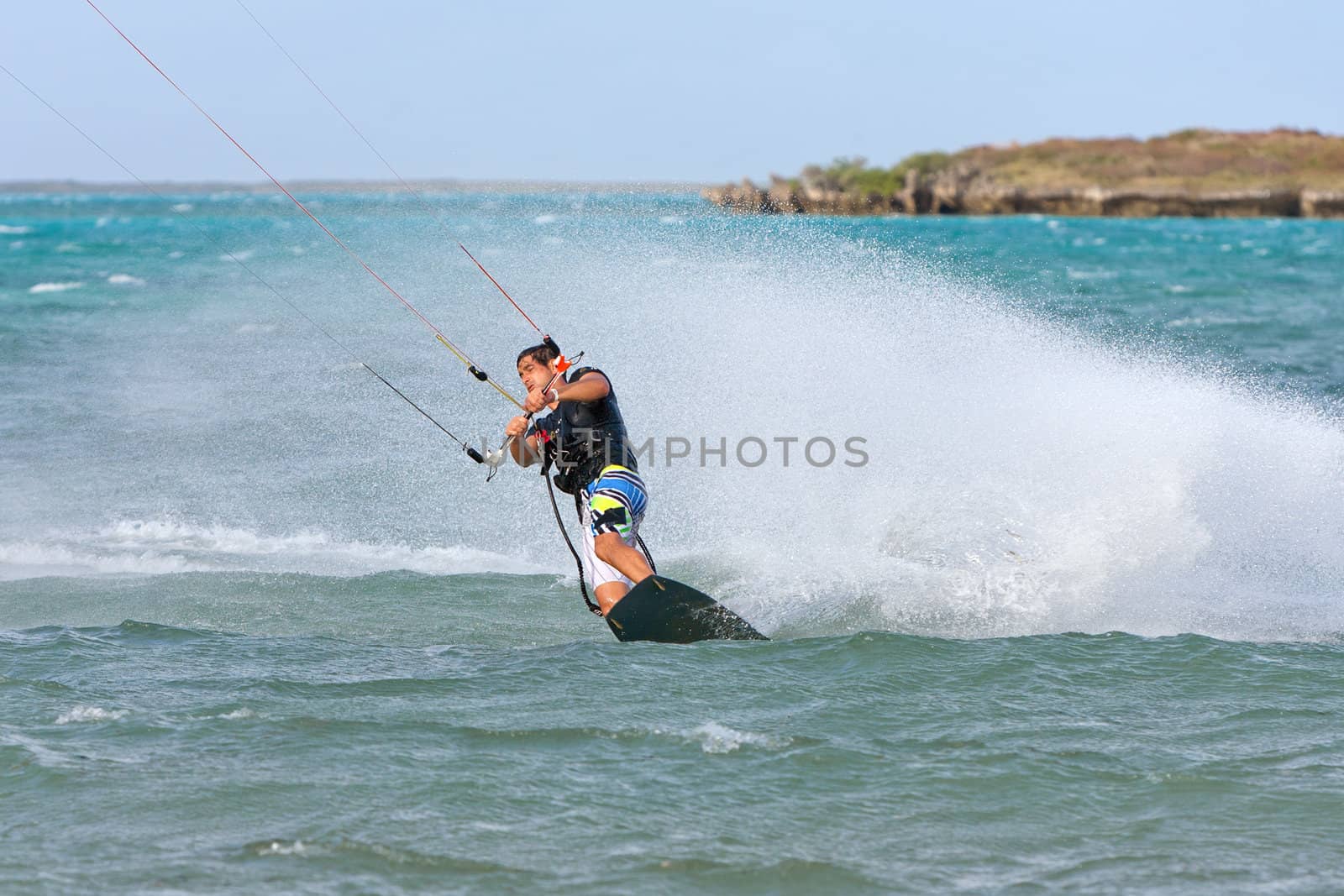 Male kitesurfer enjoying his sport in the lagoon of Babaomby, Madagascar