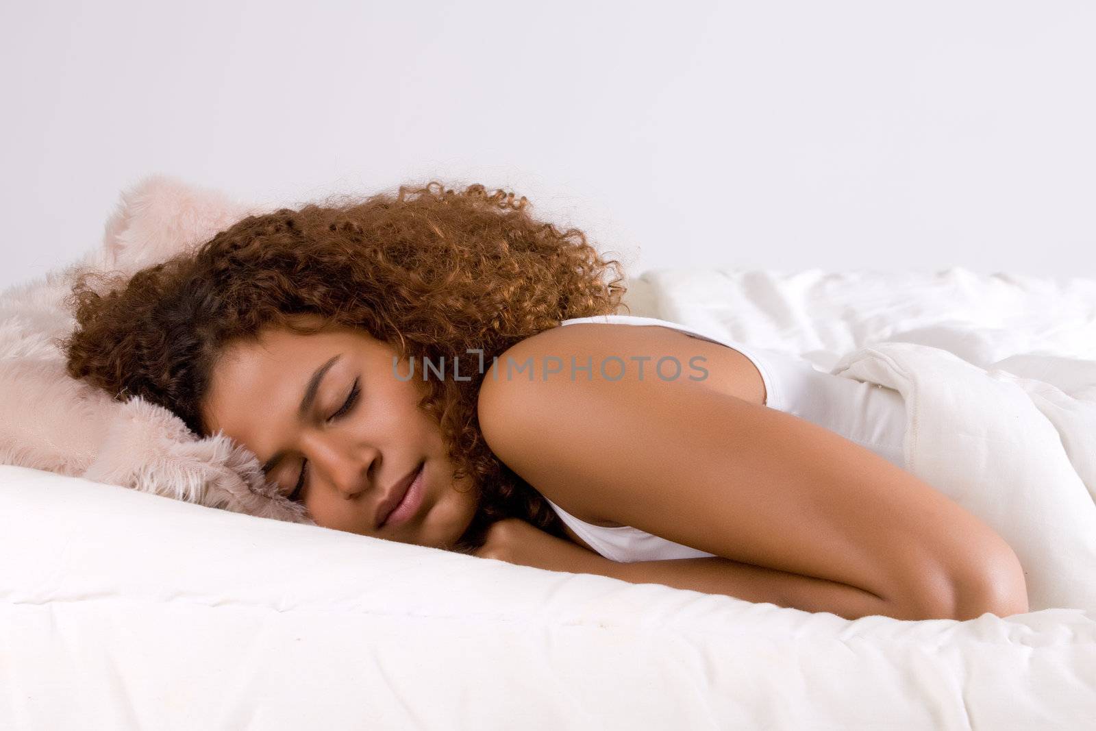Cute african girl is falling a sleep in her bed