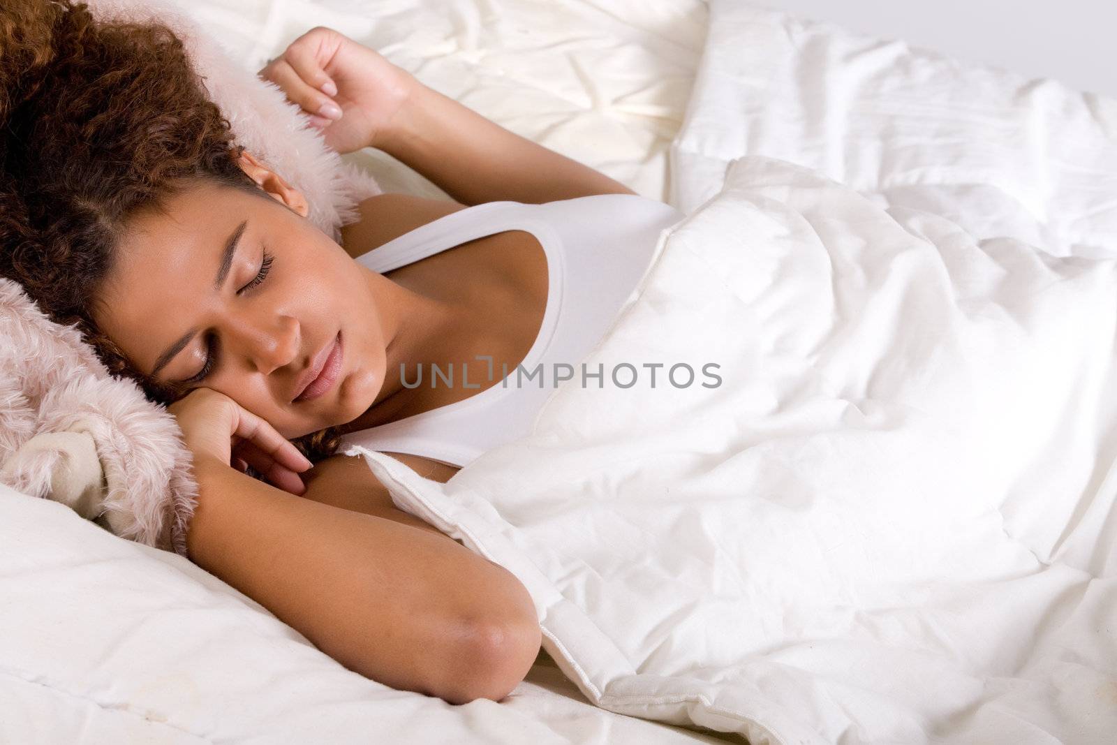 Cute african girl is falling a sleep in her bed