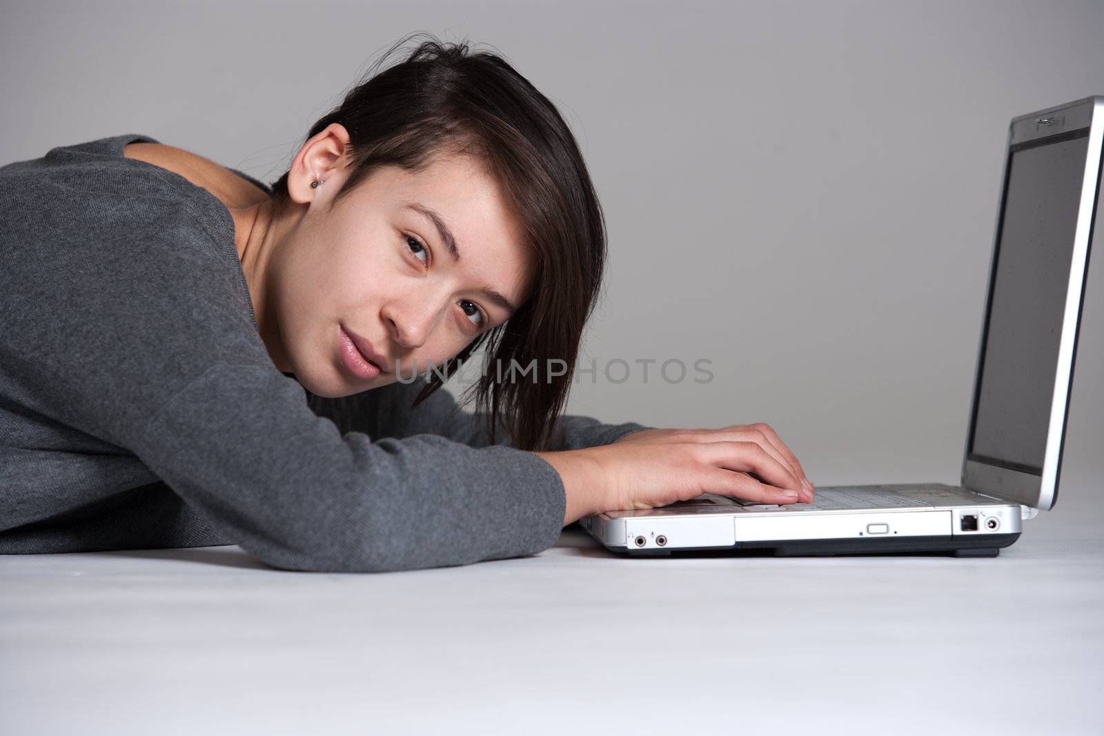 Young woman on floor with notebook by DNFStyle