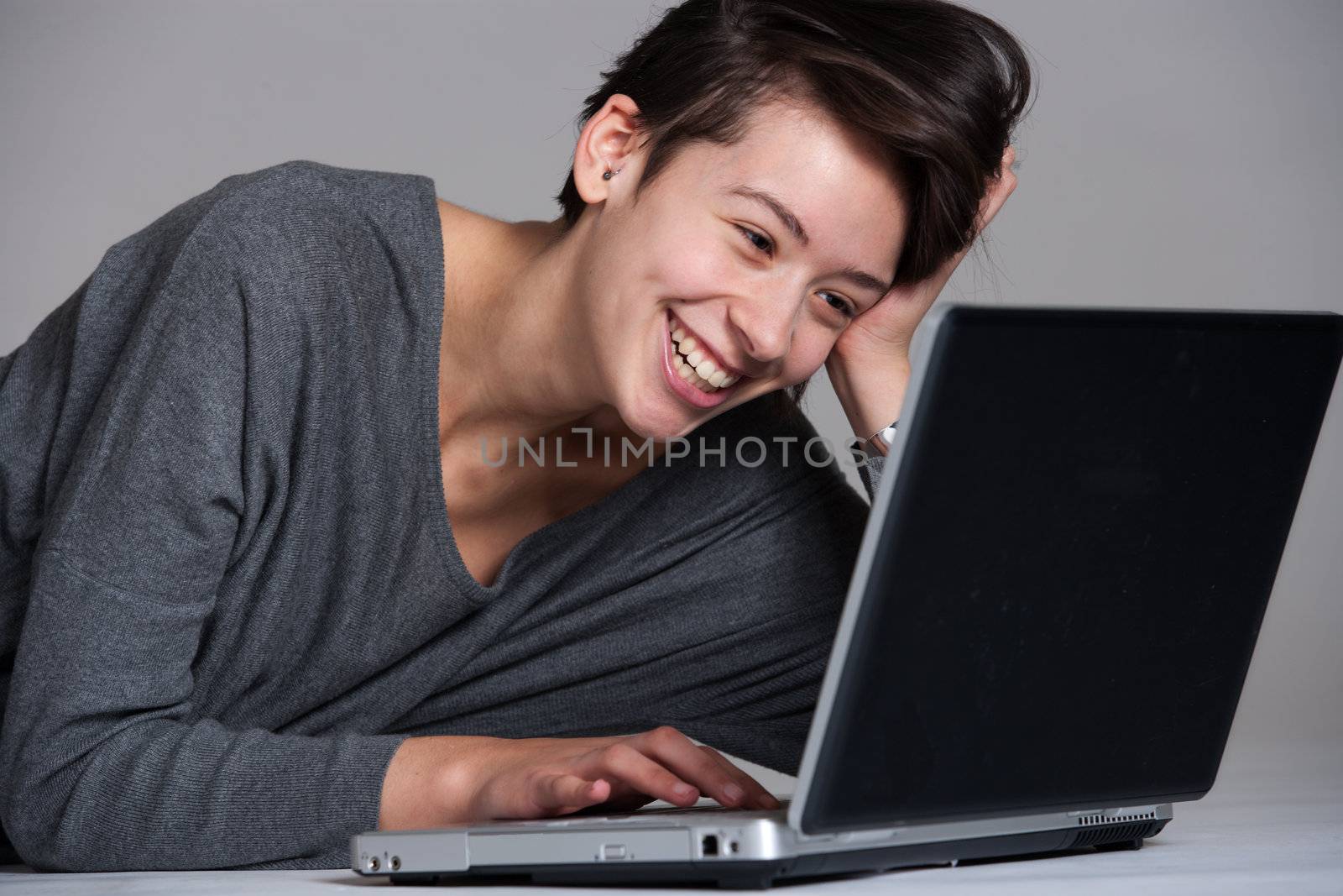 Young woman on floor with notebook by DNFStyle