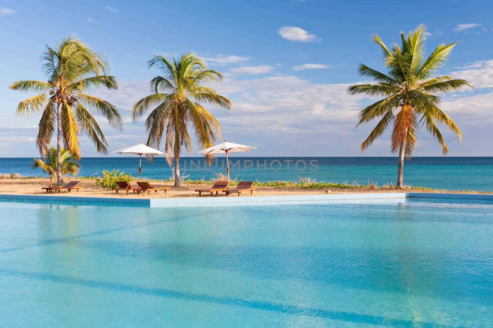 Swimming pool facing the lagoon in a tropical hotel