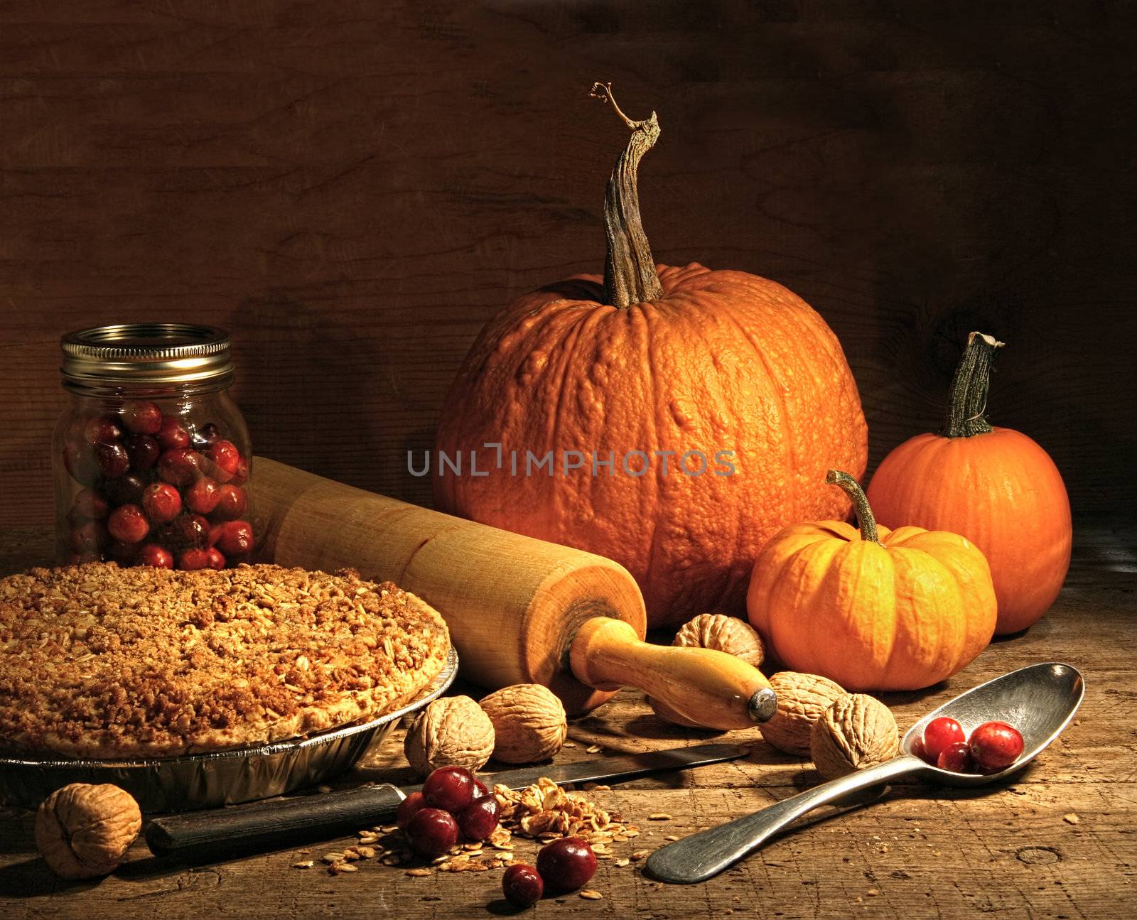 Freshly baked pie with pumpkin , nuts and cranberries on rustic table