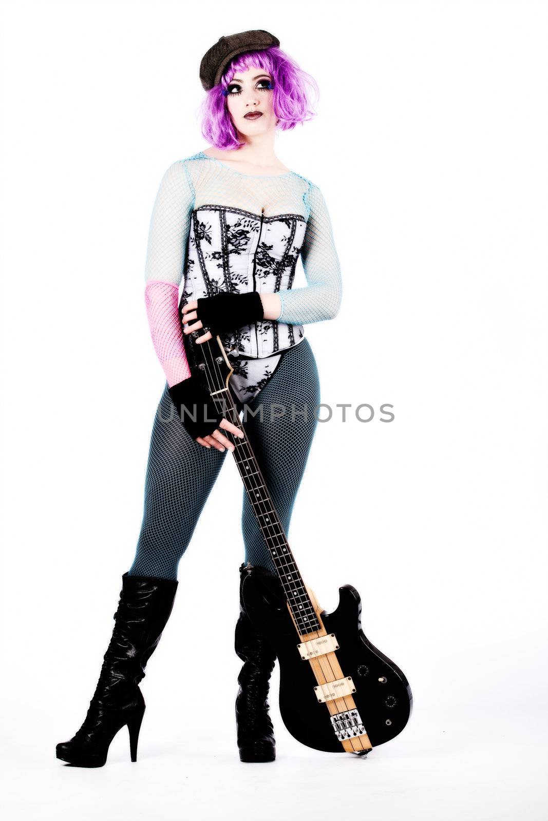 Studio portrait of a harajuky style dressed girl and her guitar