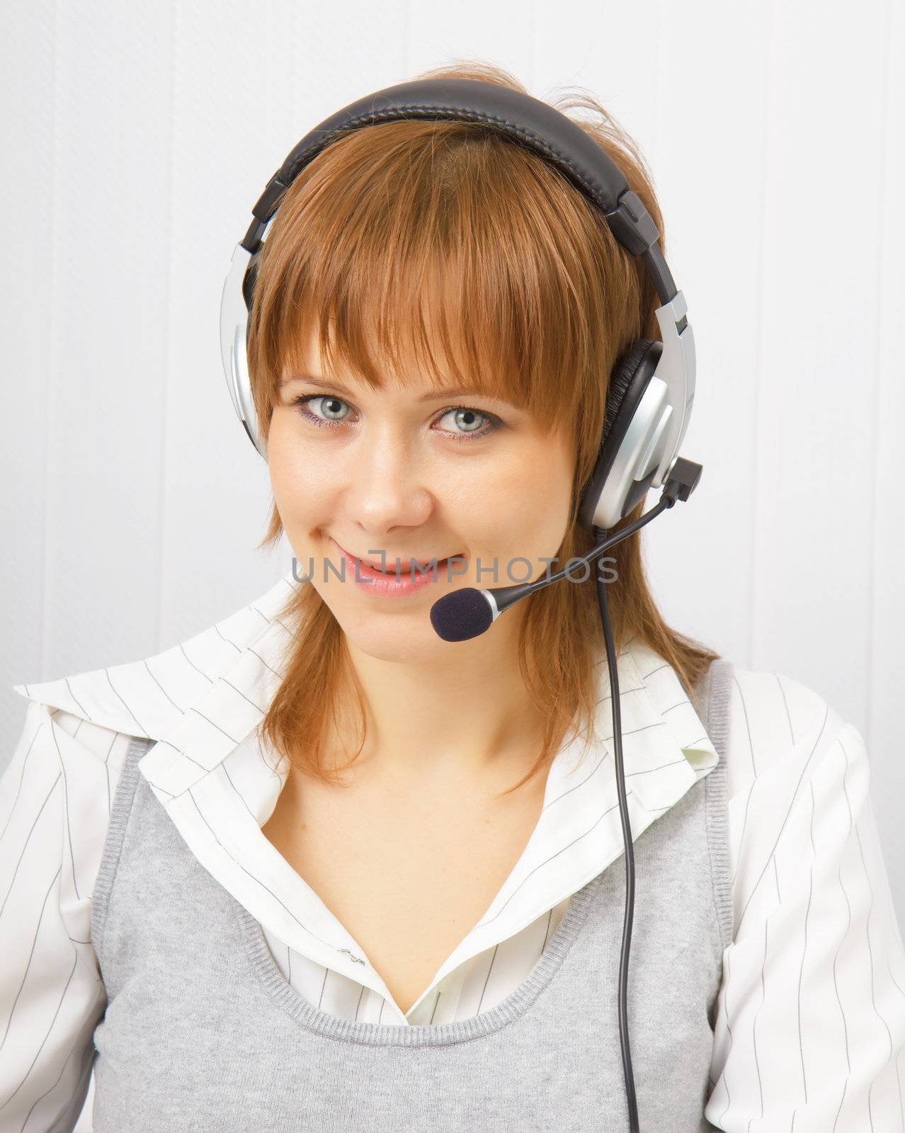 attractive girl in headphones with a microphone. Studio portrait
