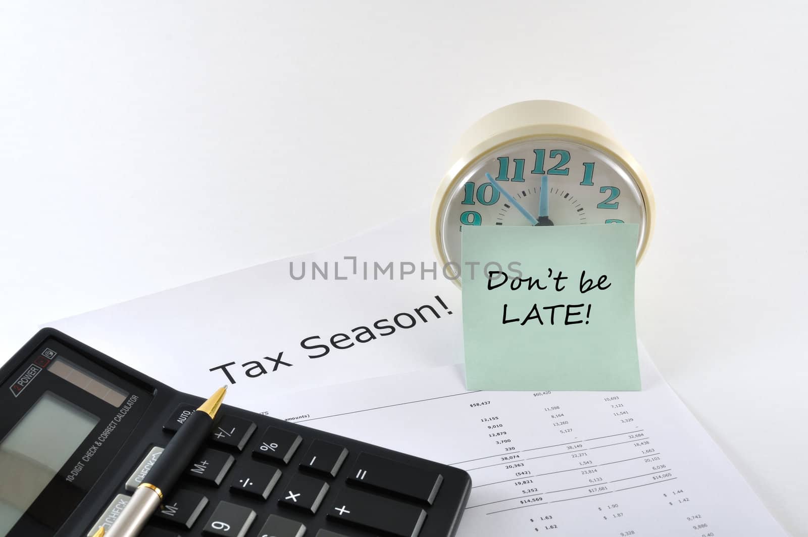 Tax Season. Don`t be late. Concept Image with calculator and clo by lobzik