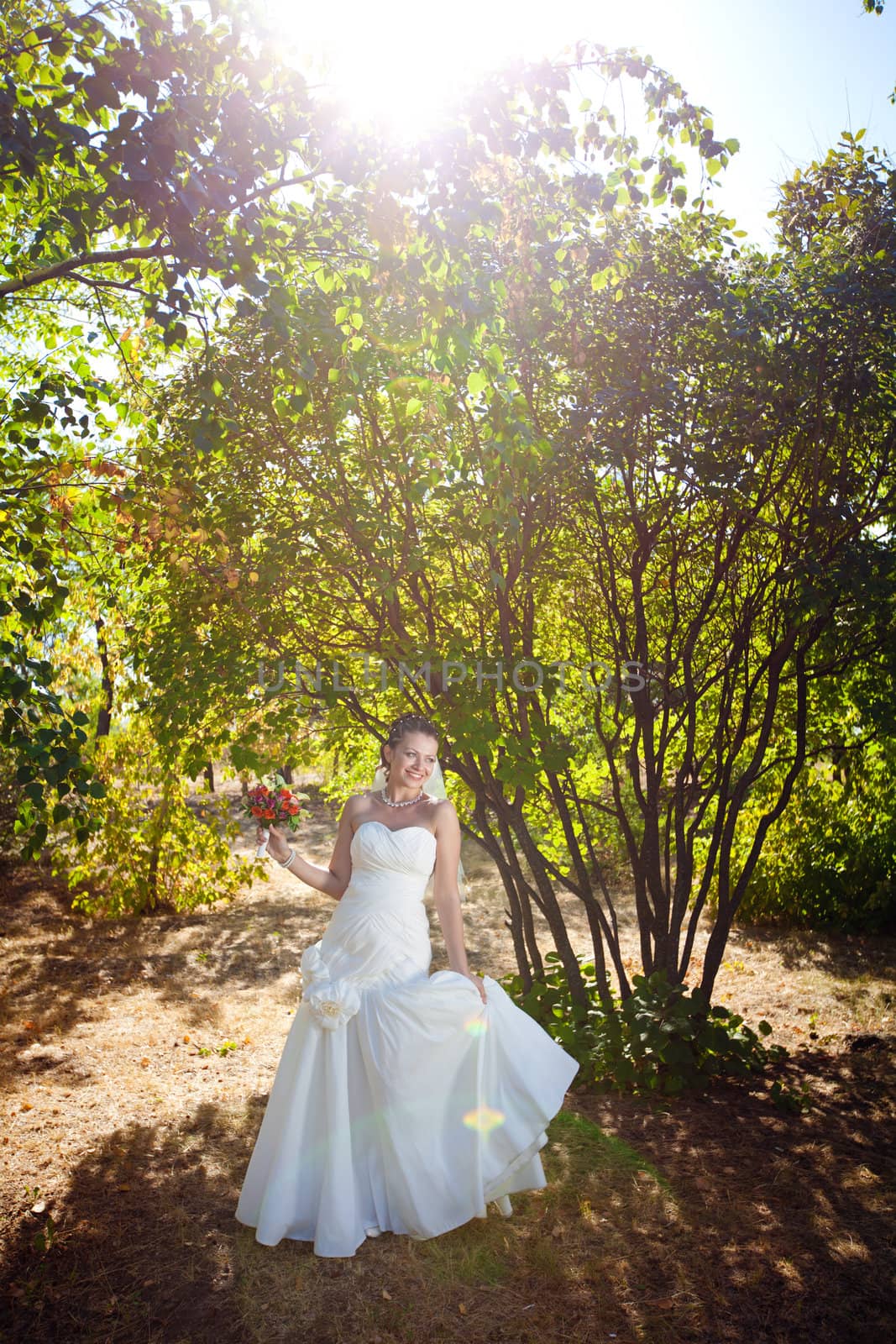  bride dancing in the sunlight outdoors