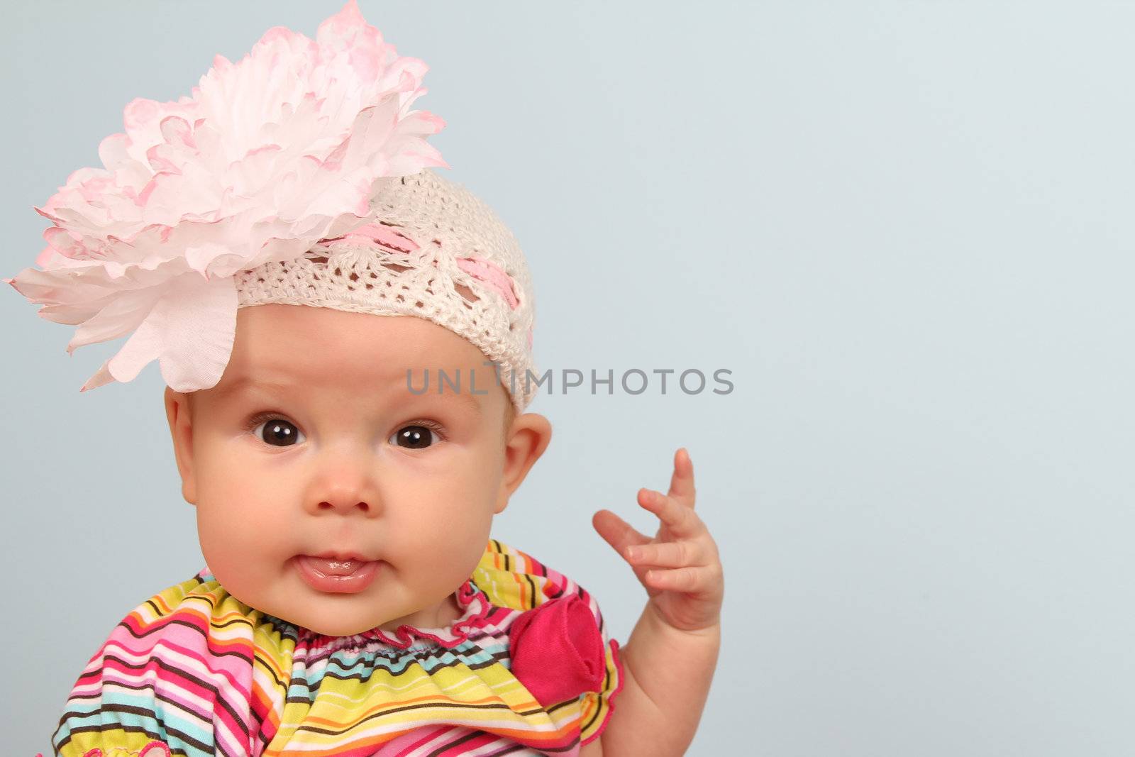 Cute baby girl wearing a beanie with large flower