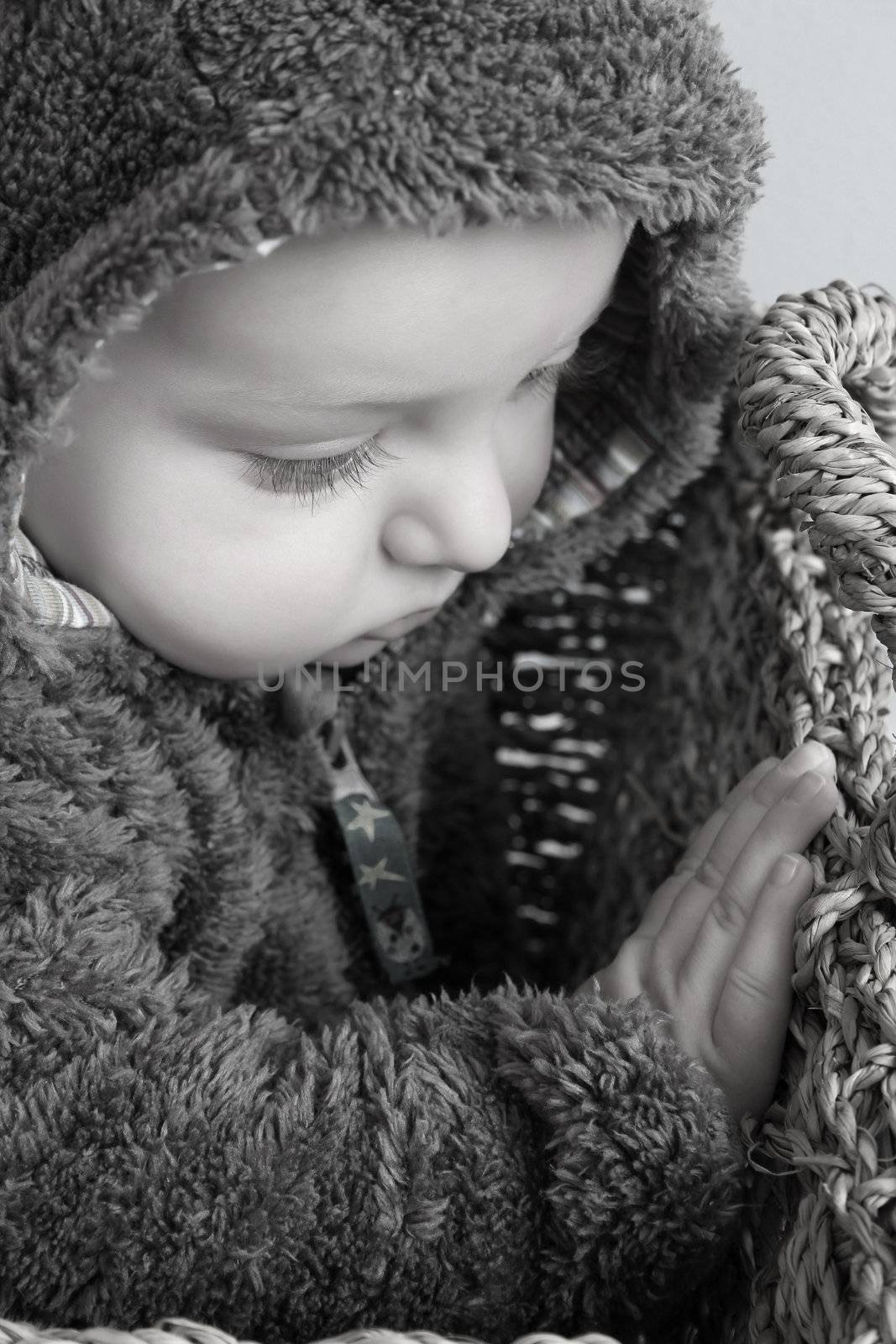 Four month old baby boy wearing a fully bear suit