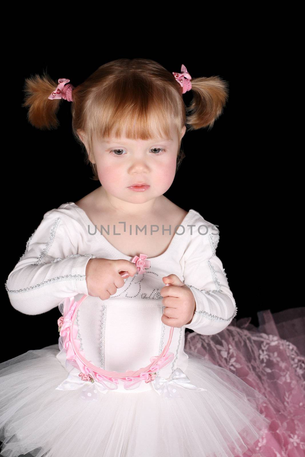 Little ballet toddler wearing a white tutu 