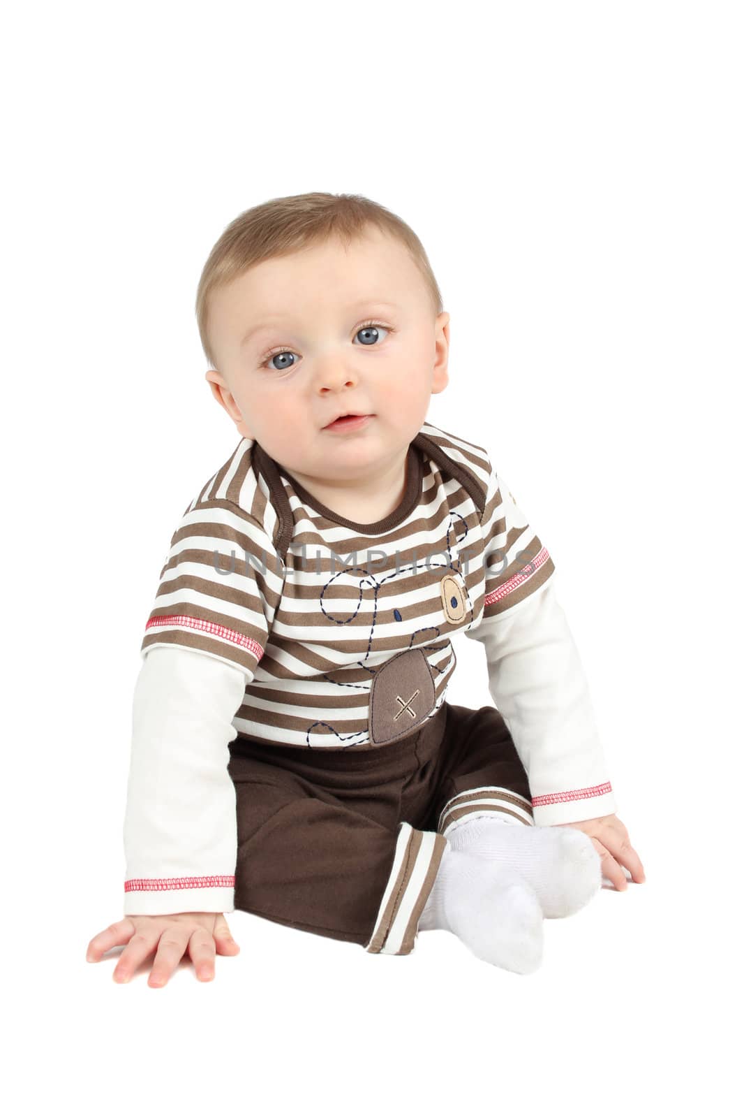 Cute baby boy sitting against a white background