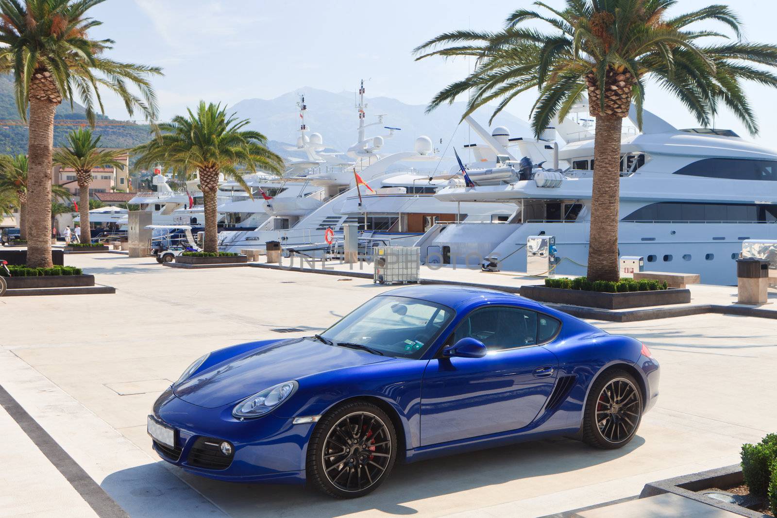 Luxury yachts and metallic sports car in Montenegro