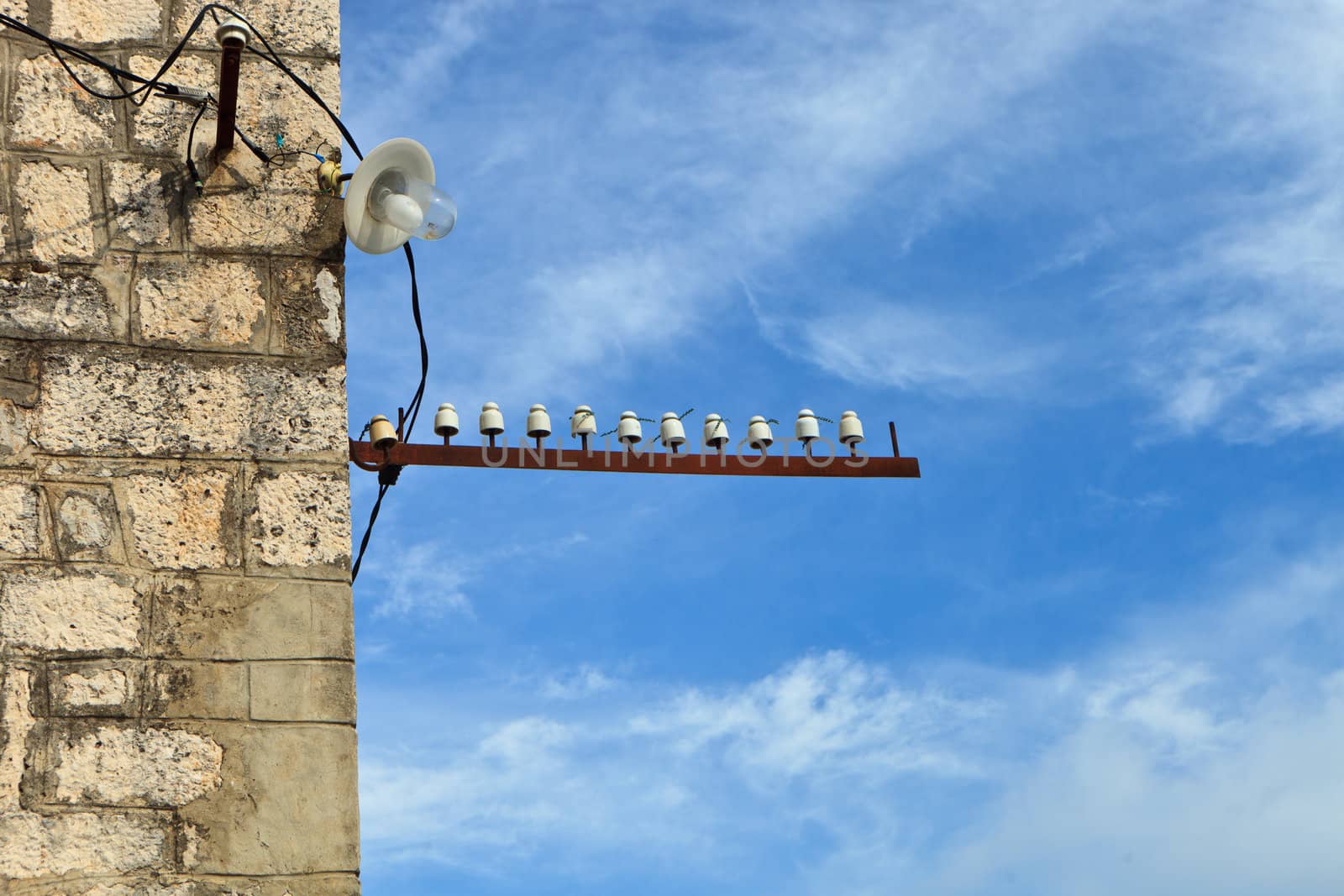 Porcelin telephone connectors outside on a stone wall