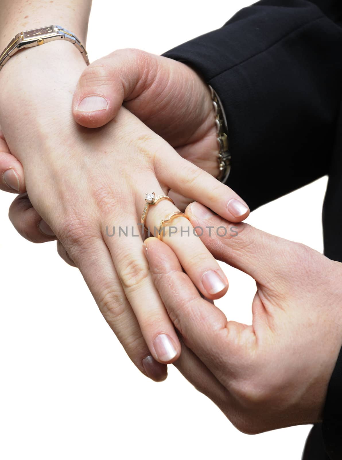 groom placing ring on finger of bride isolated on white
