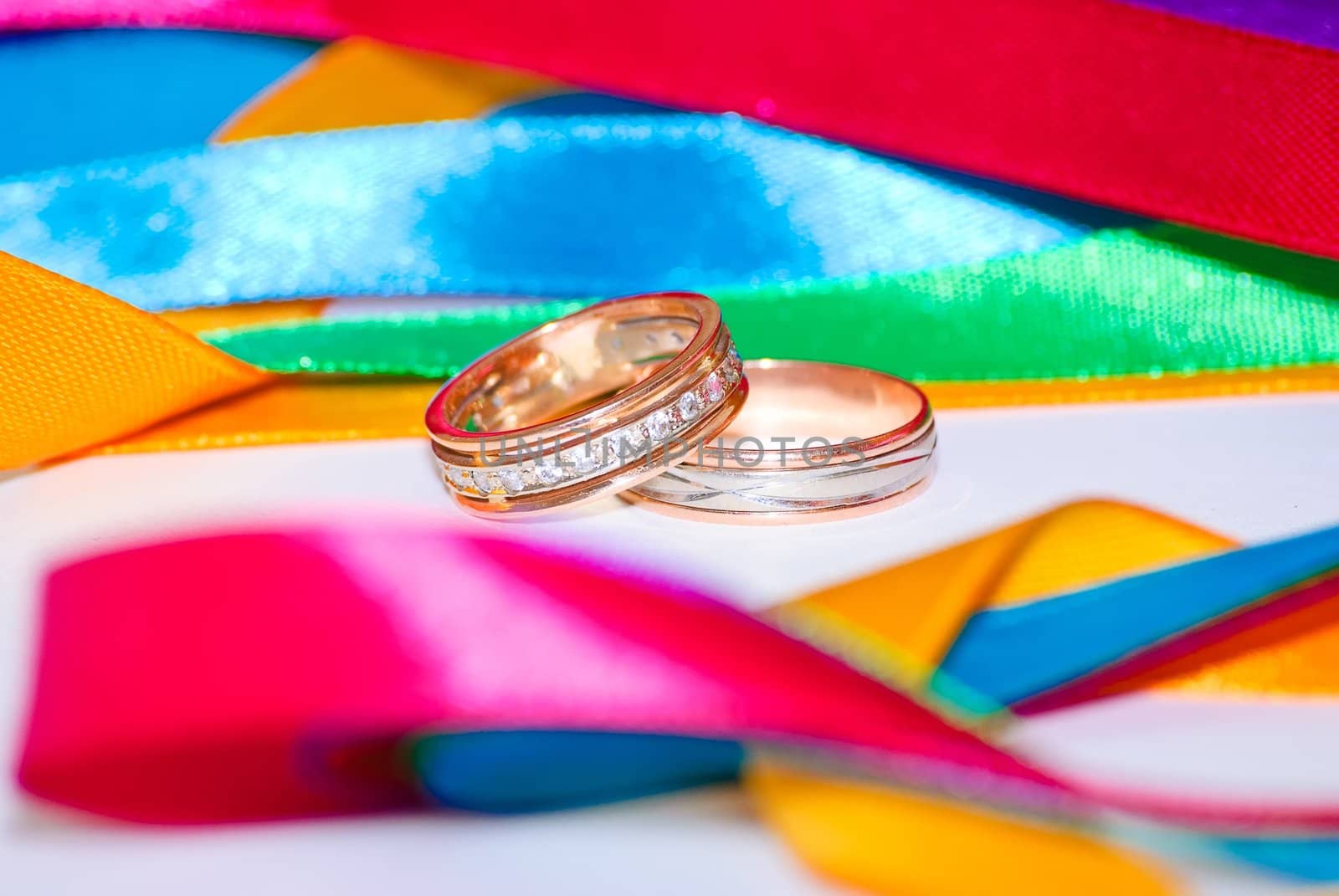 Wedding bands and colorful ribbons. Close-up.