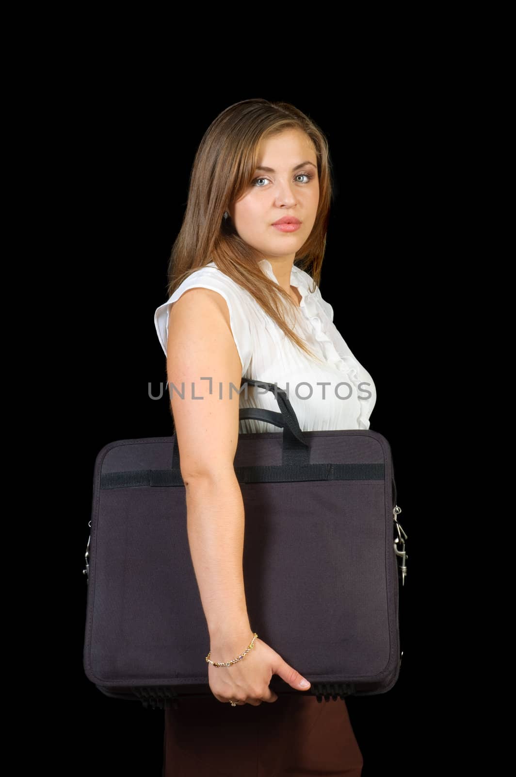 young Hispanic woman carrying a laptop case under her arm over a black background