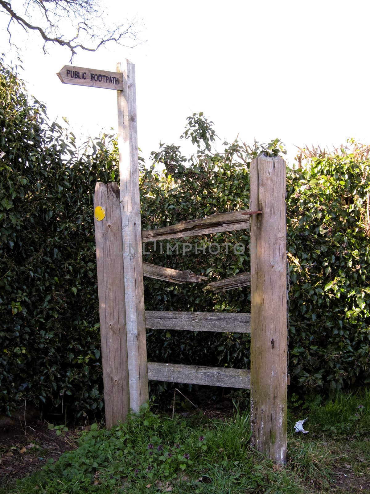 Sign for Public Footpath and broken fence