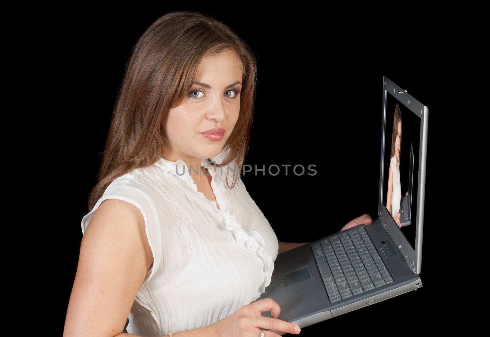 Fashion model holding laptop computer checking photographers images over a black background