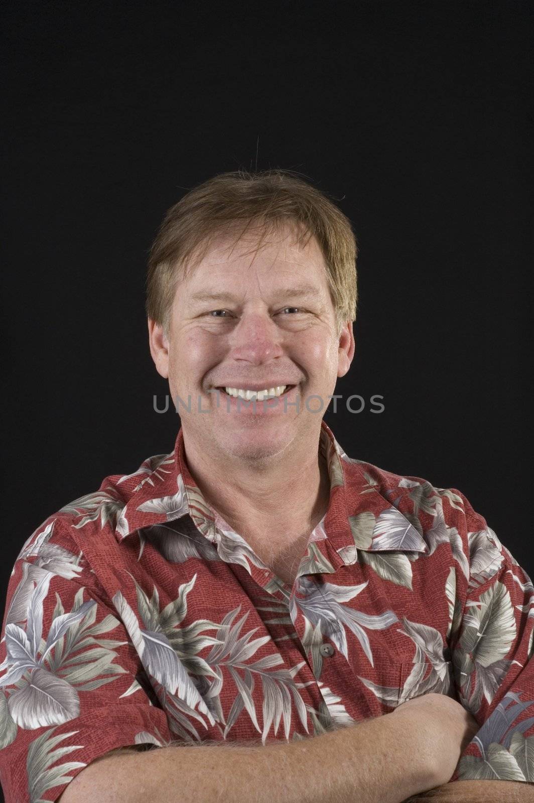 unshaven middle aged man in floral shirt man isolated on black