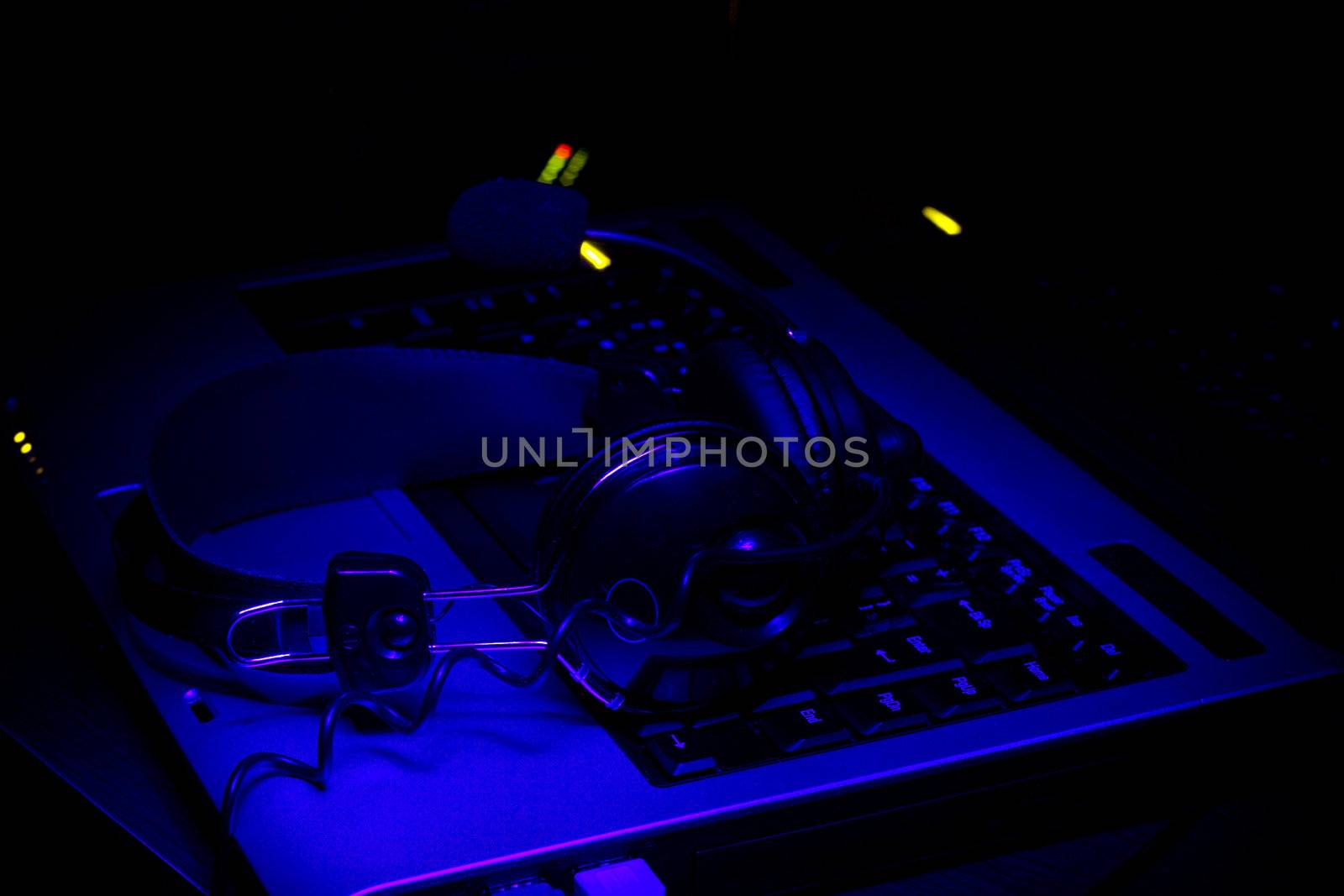 notebook keyboard and phones with microphone in ultra-violet rays