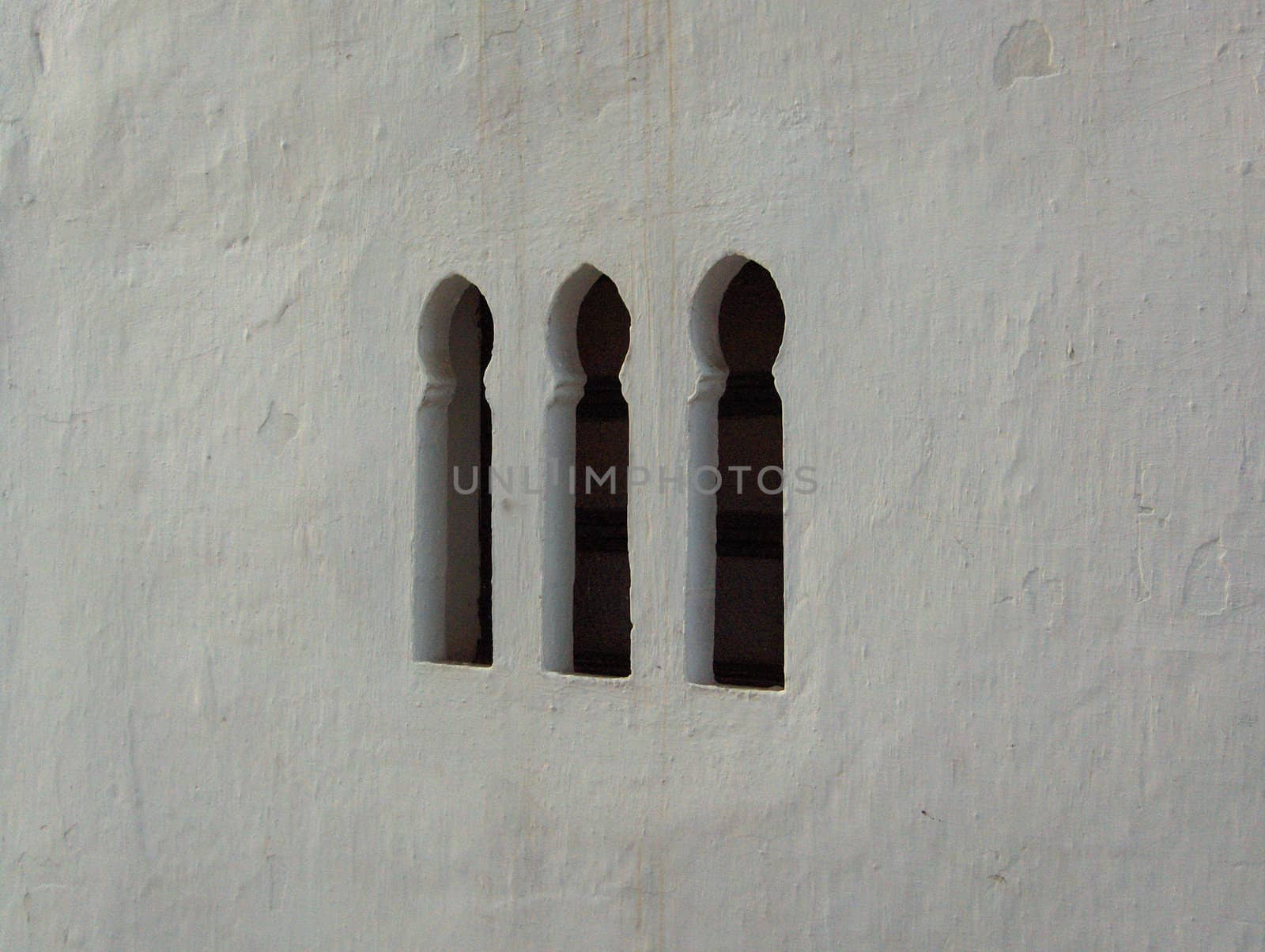 Windows in a white wall in Tangier, Morocco