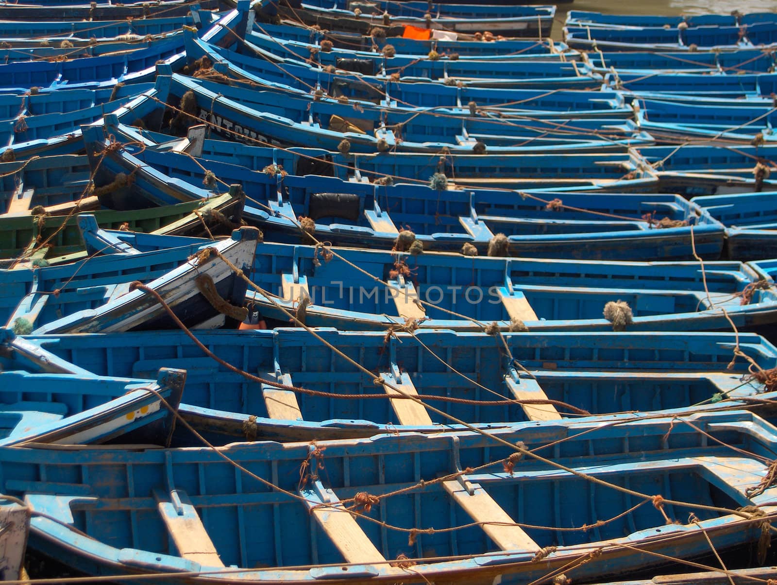 Blue painted fishing boats in harbour.