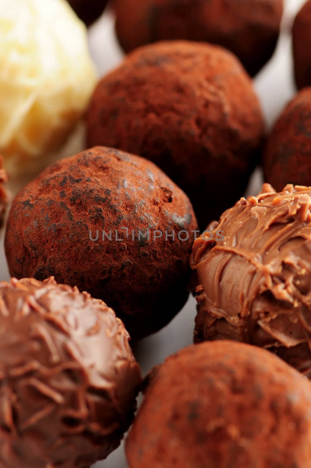 Several assorted gourmet chocolate truffles close up
