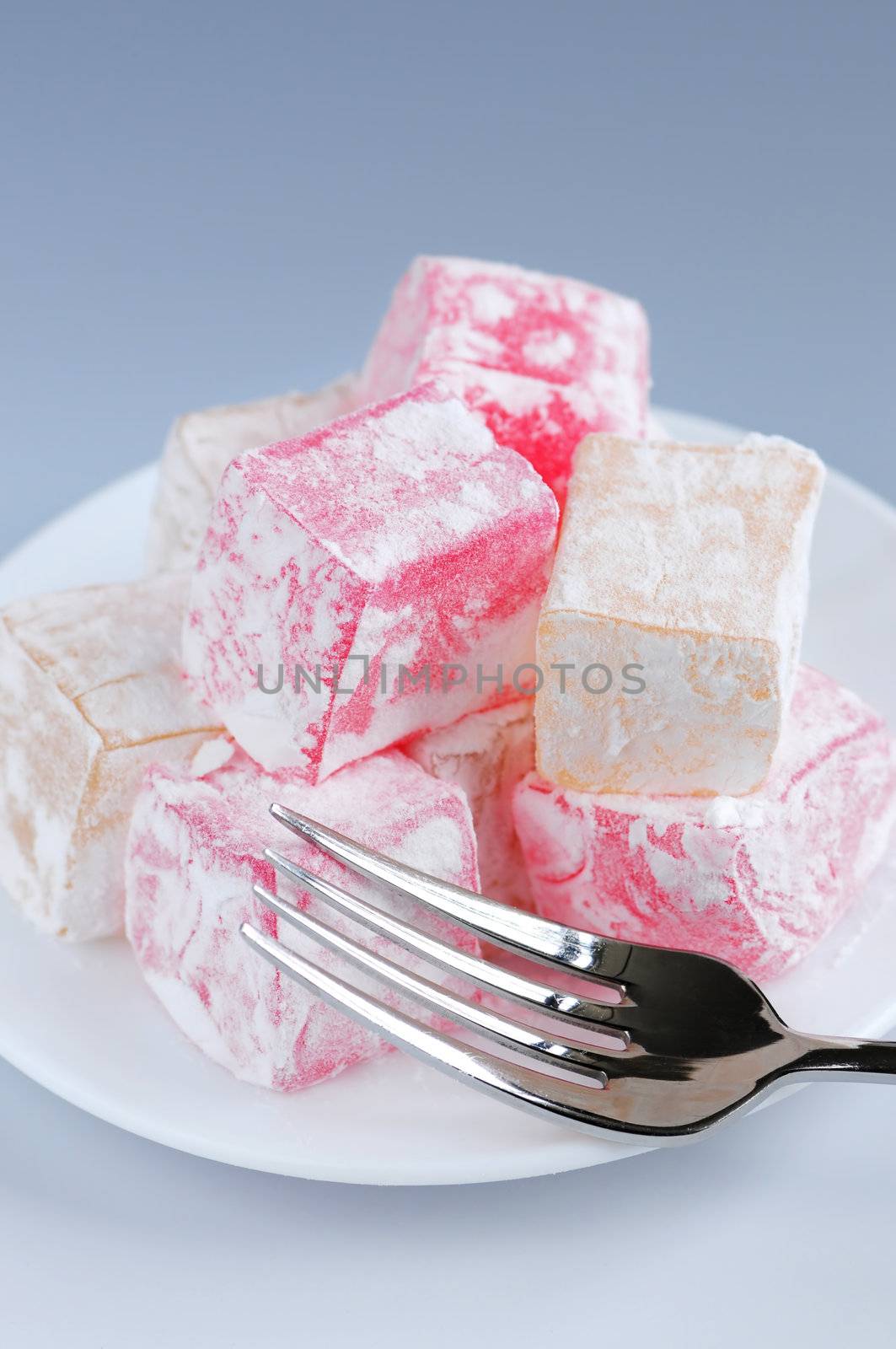 Turkish delight (lokum) confection on a white dessert plate