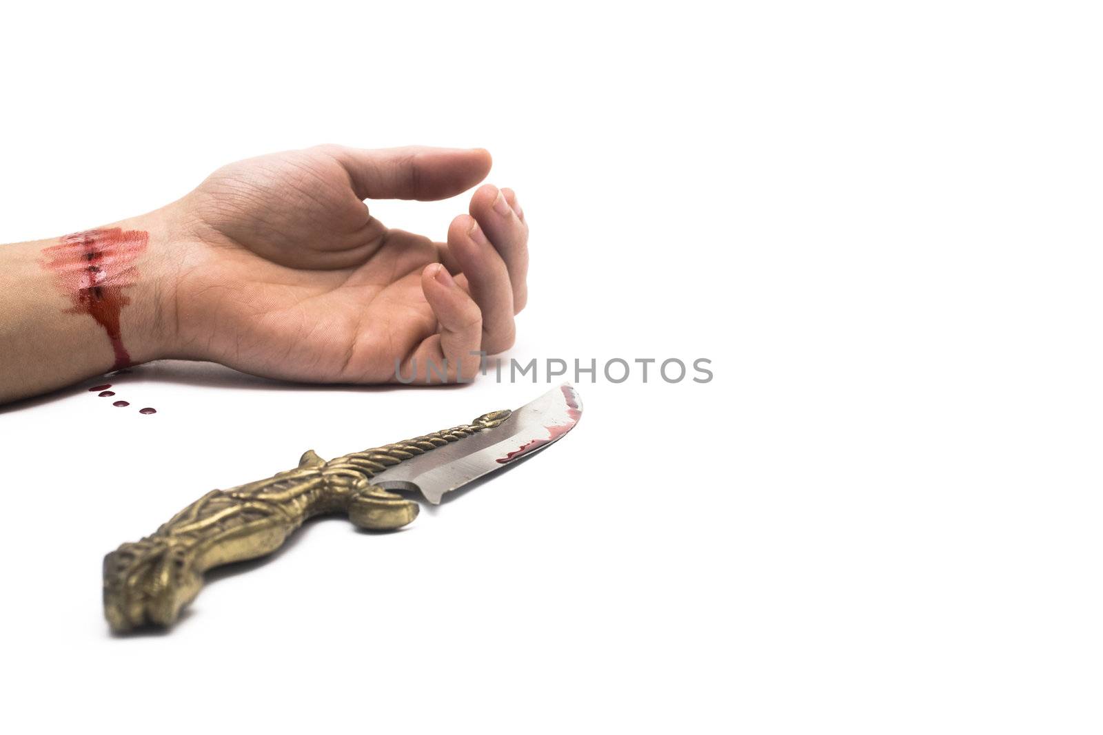 A bloody knife and a cut wrist, isolated on white. This image has innumerous uses like accidents, domestic violence, suicide, murder, hate, etc...
