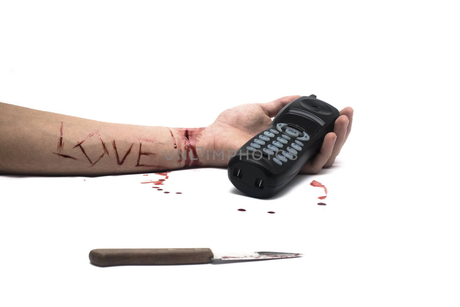 A bloody knife and a cut wrist, isolated on white with a telephone and LOVE cut across the arm. This image has innumerous uses like accidents, domestic violence, suicide, murder, hate, etc...
