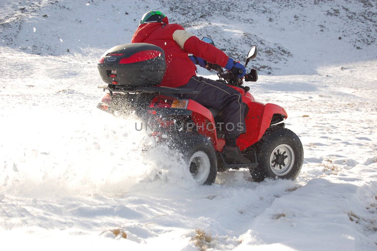 Quad in mountain snow