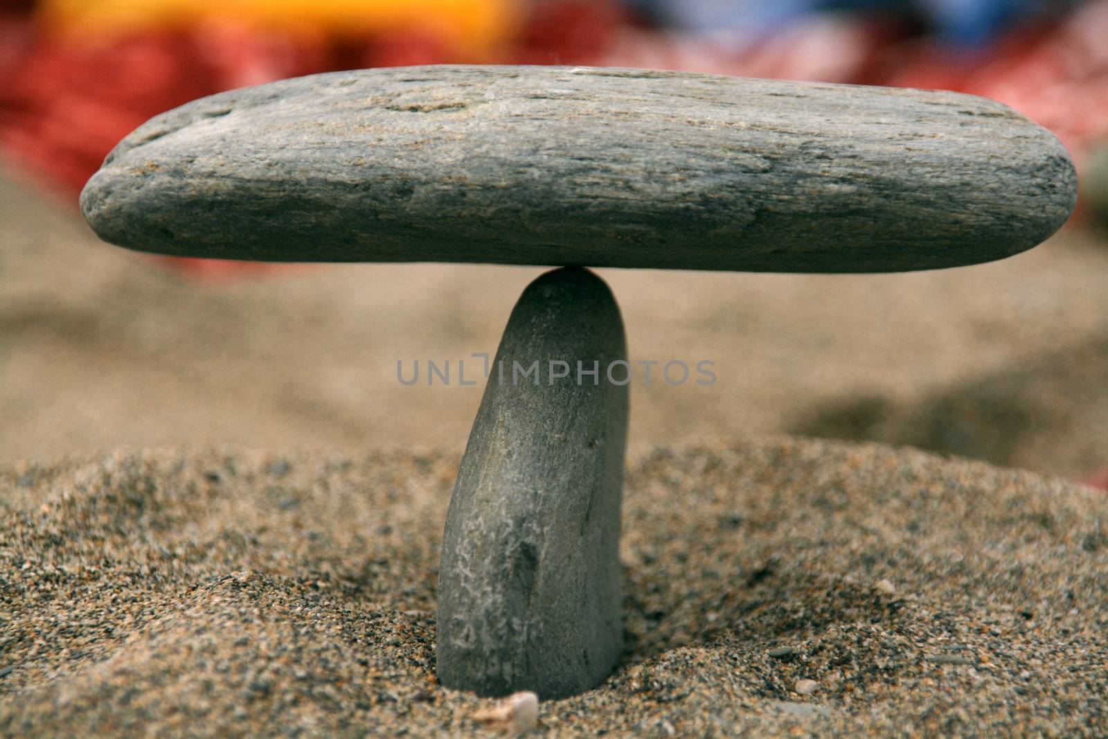 two stones in equilibrium, sand beach backgorund