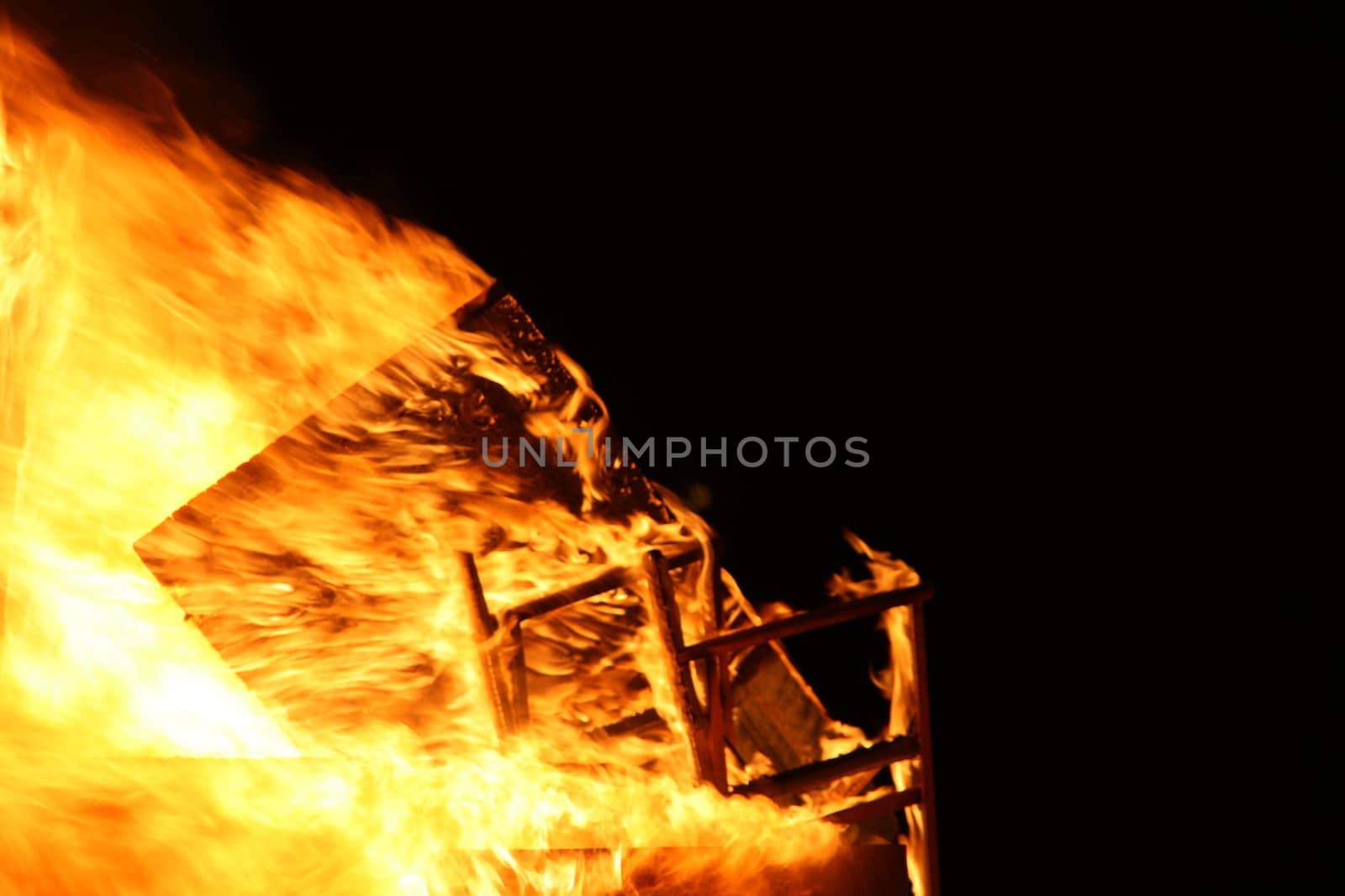 a house burning in flames, accidental fire