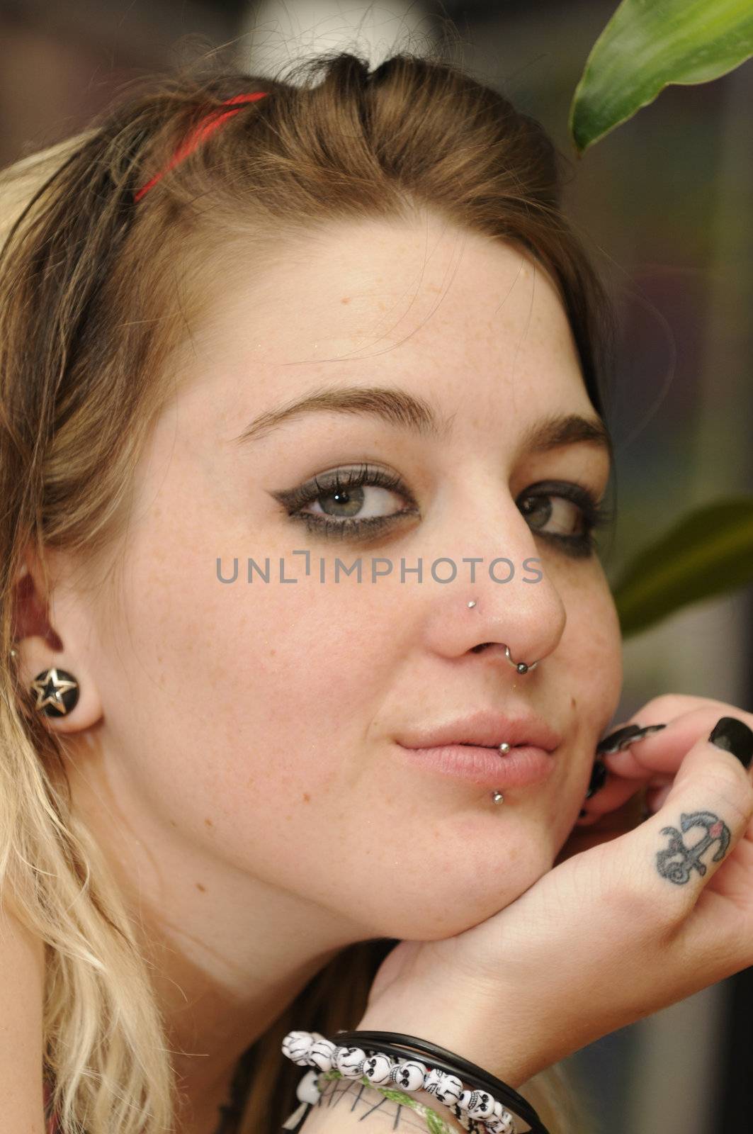 Young woman with tattoo and piercings
