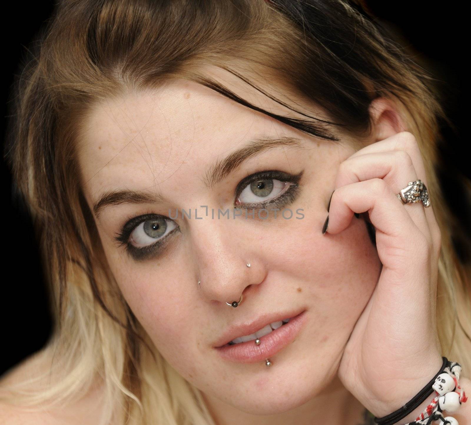 Attractive female with a nose ring and lip peircing