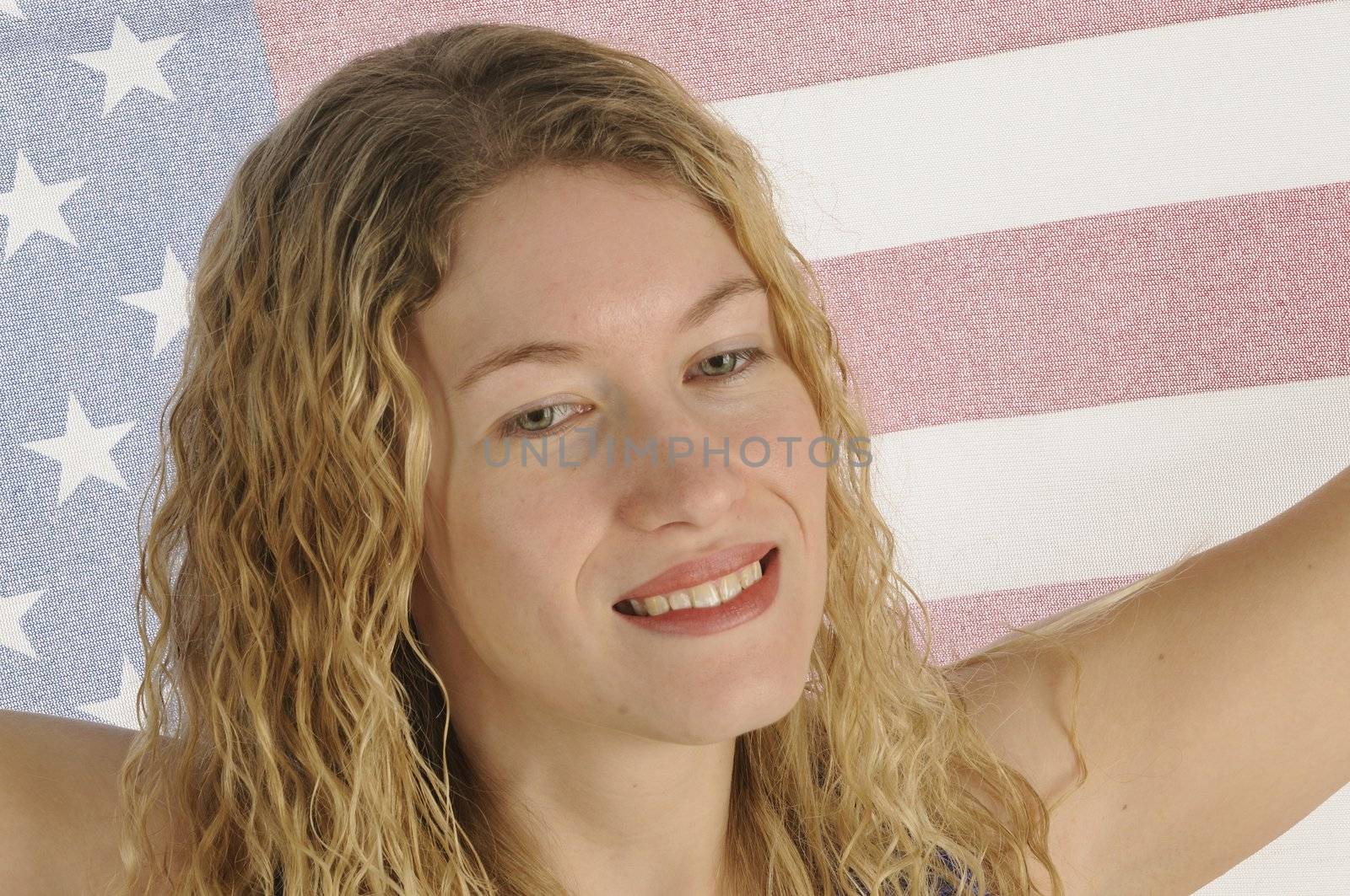 Attractive female American Patriot with flag by jeffbanke
