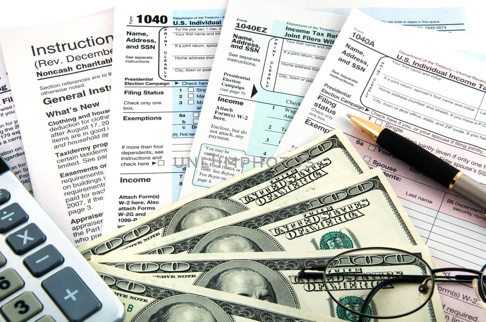 The tax forms with the glasses, money and the pen.
