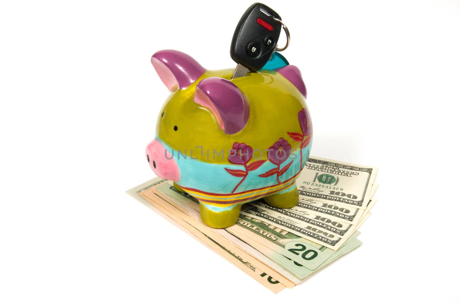 Colored piggy bank with key for car and money.