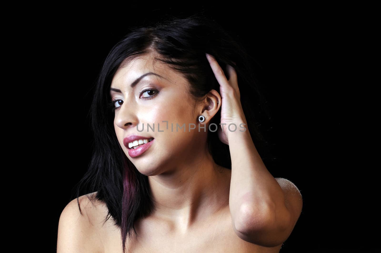 Beautiful young brunette woman adjusting hair