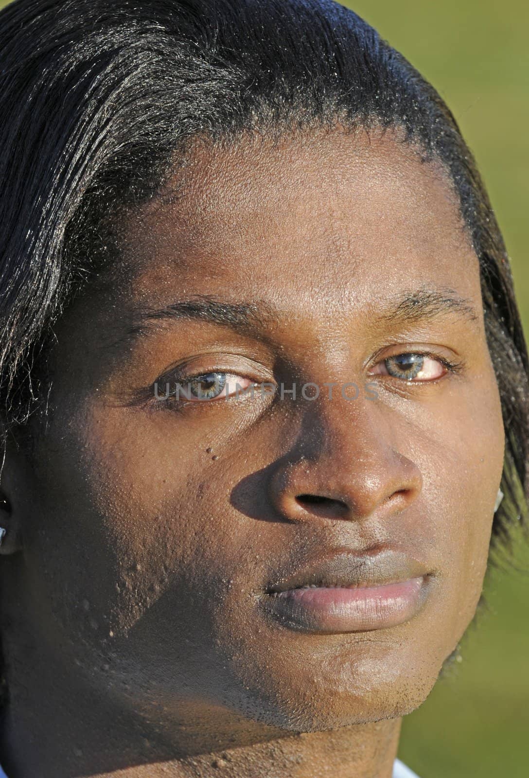 closeup of a young African American man with bloodshot eyes from allergies