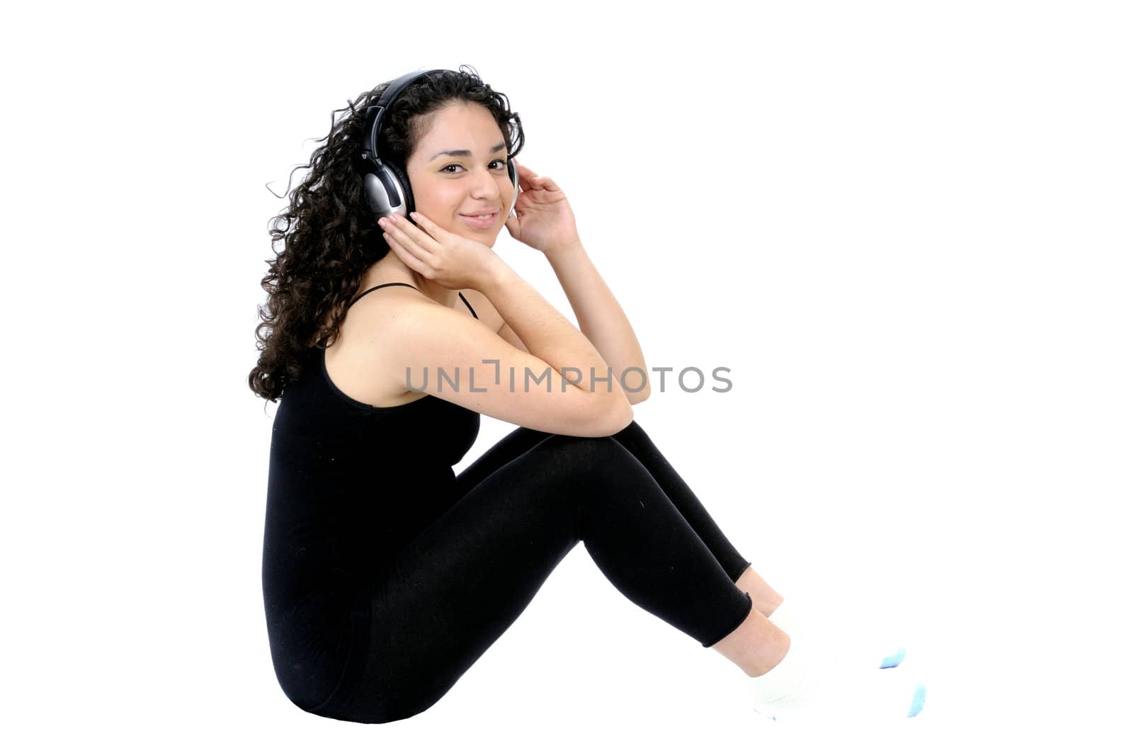 Beautiful young brunette hispanic girl listening to music, isolated on white
