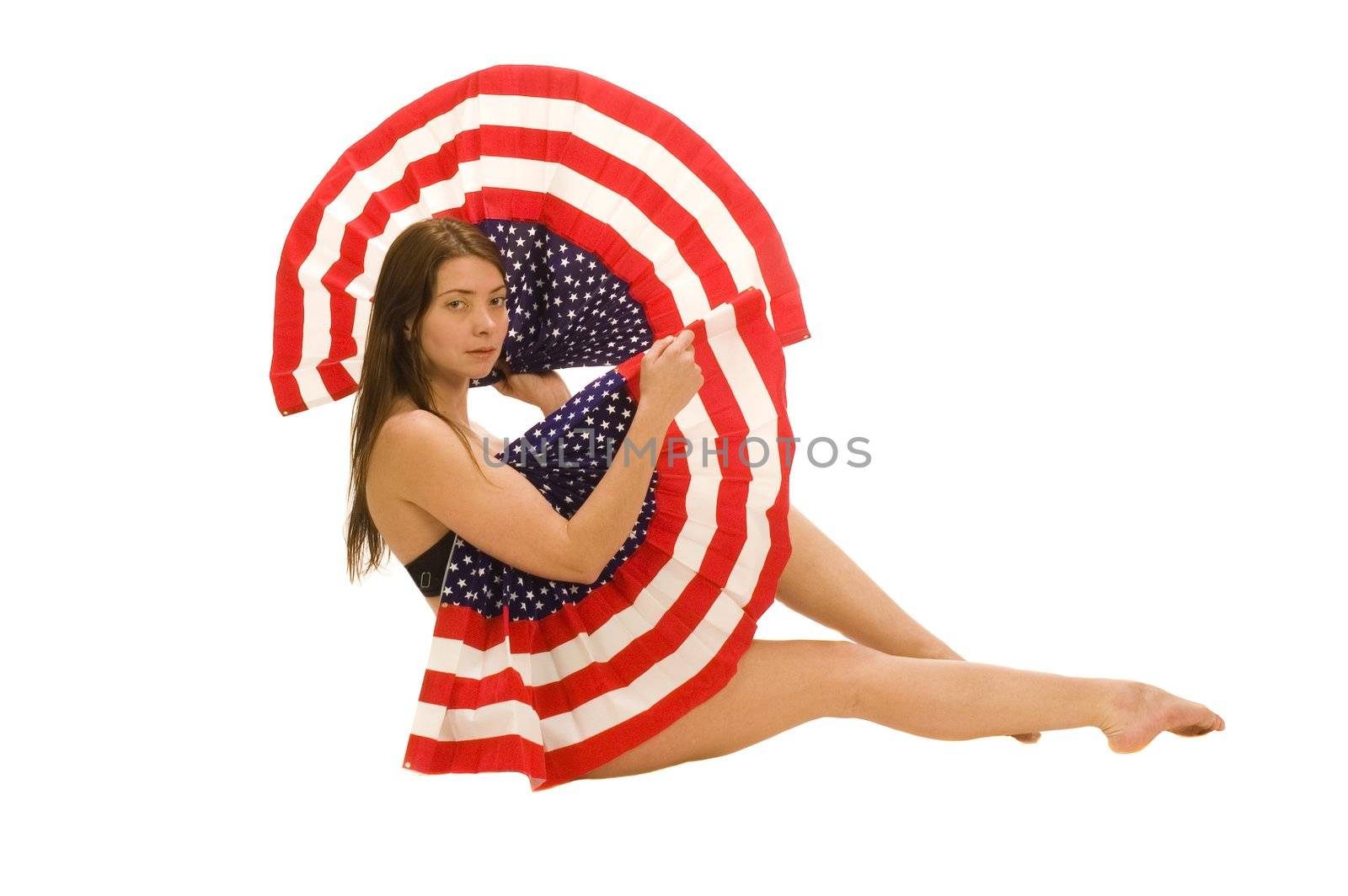 Attractive female American patriot with flag isolated over white